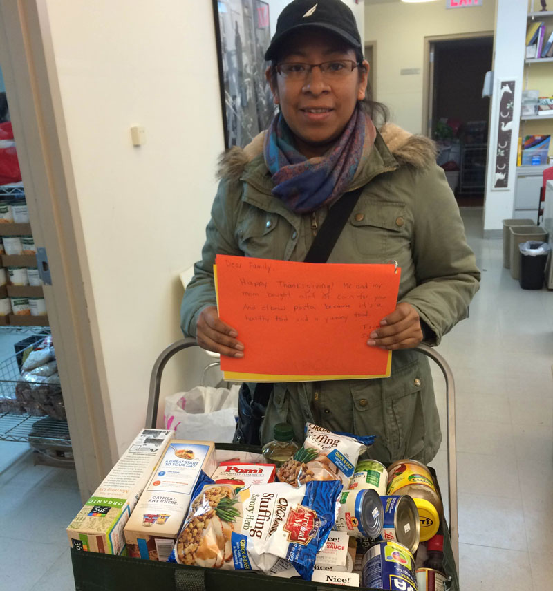 A mom picks up groceries donated by families from Horace Mann.